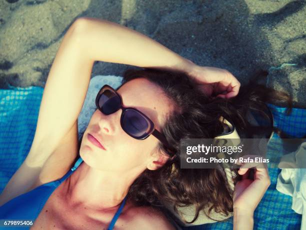 pretty lady suntanning on the beach - hairy body woman stock pictures, royalty-free photos & images
