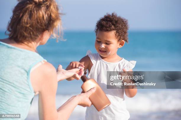 sun protection lotion for baby healthy skin. - sun safety stock pictures, royalty-free photos & images