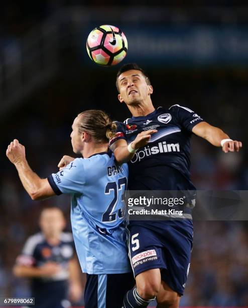 Daniel Georgievski of Melbourne Victory is challenged by Rhyan Grant of Sydney FC during the 2017 A-League Grand Final match between Sydney FC and...