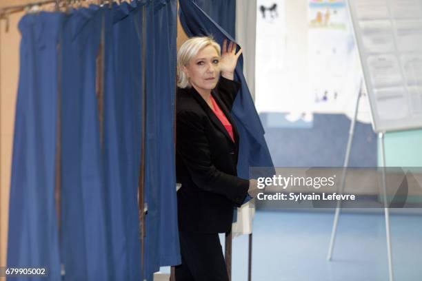 French far-right presidential candidate Marine Le Pen exits a polling booth as she votes for the 2nd round in a polling station on May 7, 2017 in...