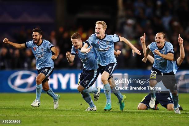 Sydney FC players celebrate after Milos Ninkovic of Sydney scores the winning penalty during the 2017 A-League Grand Final match between Sydney FC...