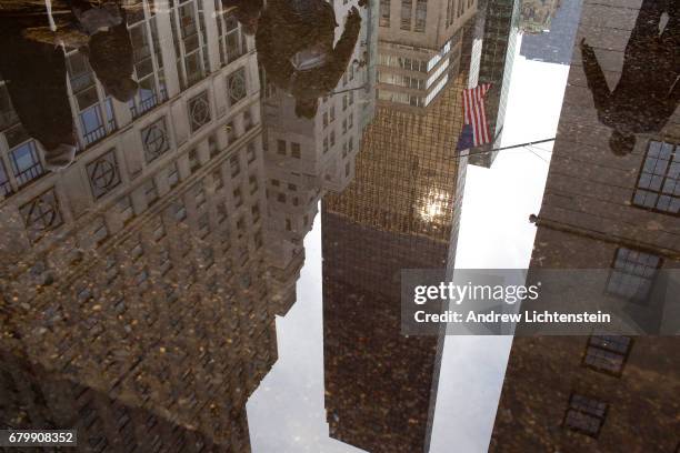 Trump Tower is reflected in a pool of rain water on 5th Avenue on February 8, 2017 in New York City.The area around Trump Tower in midtown Manhattan...
