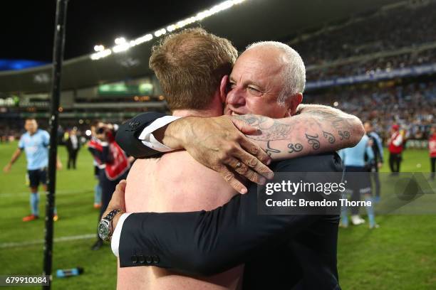 Sydney FC coach, Graham Arnold celebrates with David Carney of Sydney at full time after Sydney FC win a penalty shoot out during the 2017 A-League...