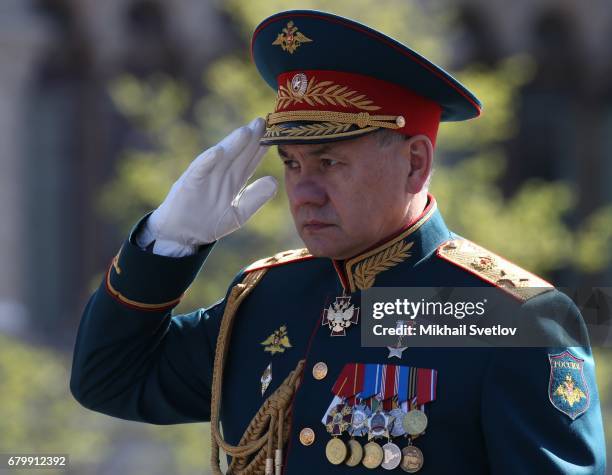 Russian Defence Minister Sergei Shoigu salutes as he rides in ZIL cabriolet along the Red Square during a rehearsal of the Victory Day military...