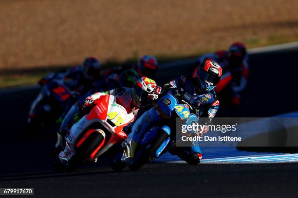 Aron Canet of Spain and Estrella Galicia 0,0 rides ahead of Lorenzo Dalla Porta of Italy and Aspar Mahindra Moto3 during warm-up for Moto3 at...