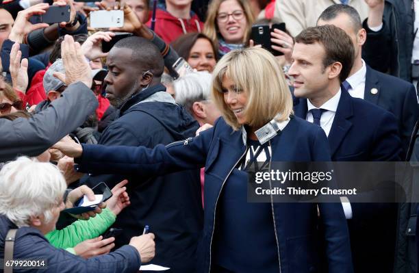 French presidential election candidate for the 'En Marche!' political movement, Emmanuel Macron and his wife Brigitte Trogneux leave the polling...