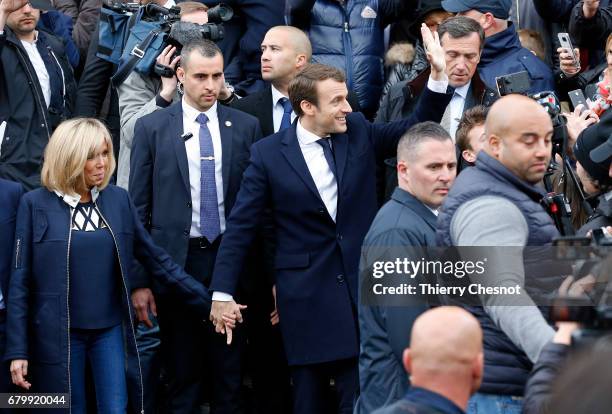 French presidential election candidate for the 'En Marche!' political movement, Emmanuel Macron and his wife Brigitte Trogneux leave the polling...