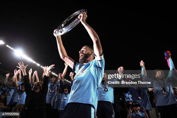 Alex Brosque of Sydney lifts the A-League trophy in front of fans following the 2017 A-League Grand Final match between Sydney FC and the Melbourne...