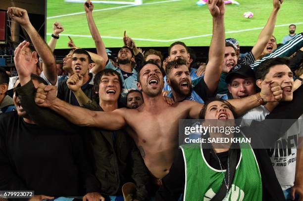 Sydney FC fans celebrate their team's victory in the 2017 A-League Grand Final football match against Melbourne Victory at Allianz Stadium in Sydney...