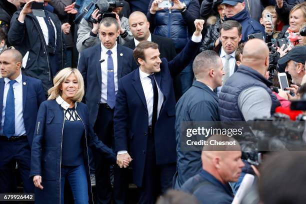 French presidential election candidate for the 'En Marche!' political movement, Emmanuel Macron and his wife Brigitte Trogneux leave the polling...