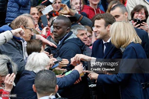 French presidential election candidate for the 'En Marche!' political movement, Emmanuel Macron and his wife Brigitte Trogneux leave the polling...