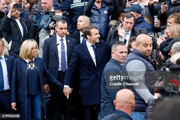 French presidential election candidate for the 'En Marche!' political movement, Emmanuel Macron and his wife Brigitte Trogneux leave the polling...