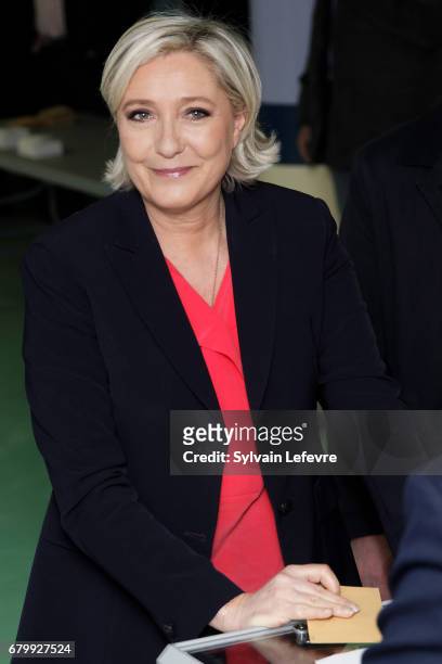 French far-right presidential candidate Marine Le Pen casts her ballot as she votes for the 2nd round in a polling station on May 7, 2017 in...