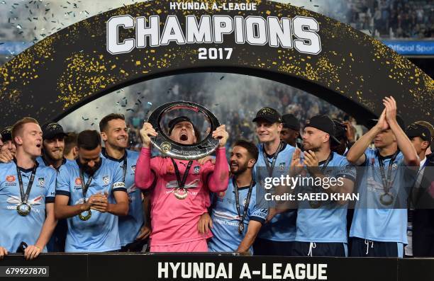 Sydney FC's goalkeeper Daniel Vukovic celebrates with his teammates after winning the 2017 A-League Grand Final football match against Melbourne...