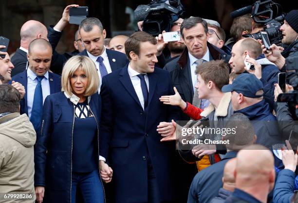 French presidential election candidate for the 'En Marche!' political movement, Emmanuel Macron and his wife Brigitte Trogneux leave the polling...