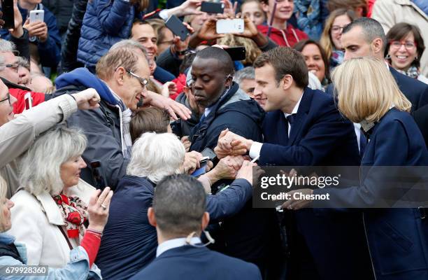 French presidential election candidate for the 'En Marche!' political movement, Emmanuel Macron and his wife Brigitte Trogneux leave the polling...