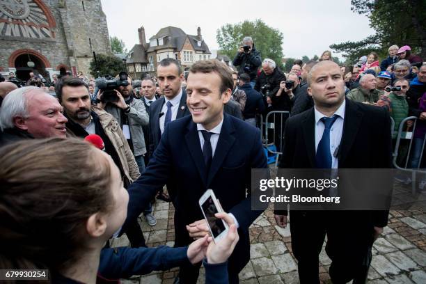 Emmanuel Macron, French presidential candidate, greets supporters after voting during the second round of the French presidential election in Le...
