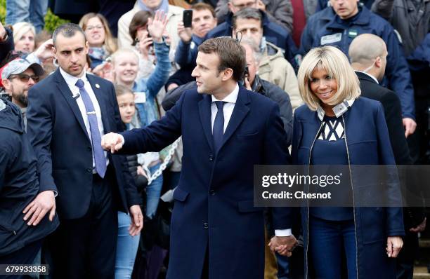 French presidential election candidate for the 'En Marche!' political movement, Emmanuel Macron and his wife Brigitte Trogneux leave the polling...