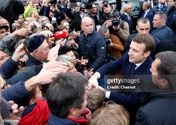 French presidential election candidate for the 'En Marche!' political movement, Emmanuel Macron meets his supporters as he leaves the polling station...