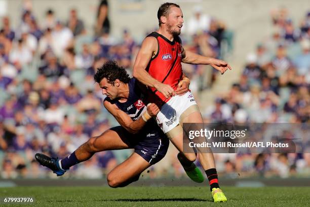 James Kelly of the Bombers is tackled by Brady Grey of the Dockers during the round seven AFL match between the Fremantle Dockers and the Essendon...