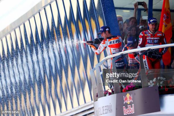 Dani Pedrosa of Spain and the Repsol Honda Team celebrates on the podium next to Jorge Lorenzo of Spain and the Ducati Team after winning the MotoGP...