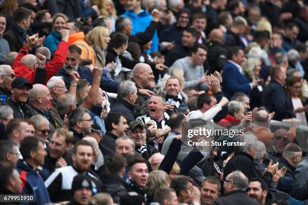 Newcastle United fans celebrate as they hear that Aston Villa have scored which awards the leauge title to Newcastle United during the Sky Bet...