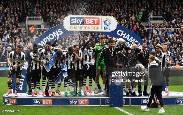 Jamaal Lascelles of Newcastle United and Jonjo Shelvey of Newcastle United celebrate with the Championship Trophy after the Sky Bet Championship...