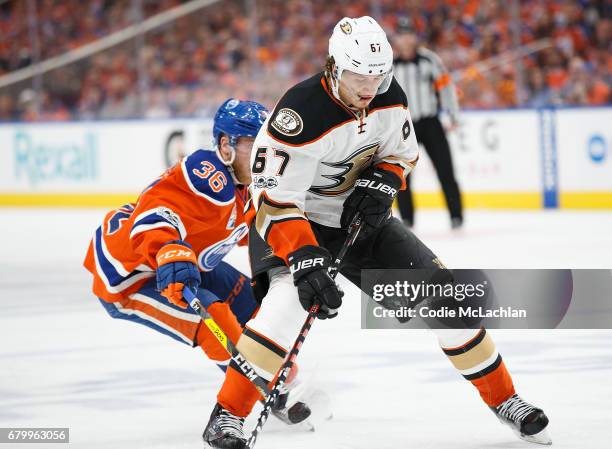 Drake Caggiula of the Edmonton Oilers battles against Rickard Rakell of the Anaheim Ducks in Game Four of the Western Conference Second Round during...