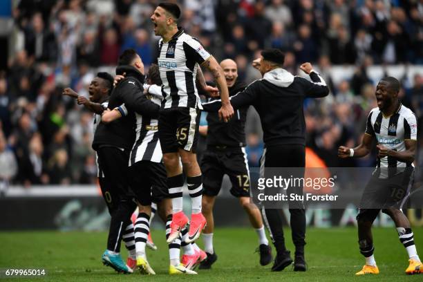Aleksander Mitrovic and team mates of Newcastle celebrate after hearing the score from the Brighton game means that they win the the Sky Bet...