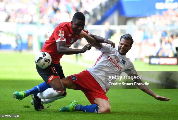 Dennis Diekmeier of Hamburg is challenged by Jhon Crdoba of Mainz during the Bundesliga match between Hamburger SV and 1. FSV Mainz 05 at...