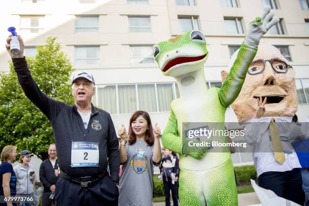 Tony Nicely, chief executive officer of the Government Employees Insurance Co. , signals the start of the "Berkshire Hathaway Invest In Yourself 5K"...