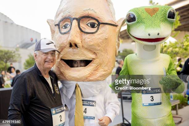 Tony Nicely, chief executive officer of the Government Employees Insurance Co. , stands for a photograph with a likeness of Charlie Munger, vice...