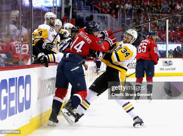 Justin Williams of the Washington Capitals checeks Tom Kuhnhackl of the Pittsburgh Penguins in Game Five of the Eastern Conference Second Round...