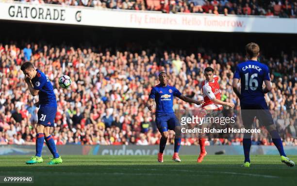 Alexis Sanchez of Arsenal scores his sides first goal during the Premier League match between Arsenal and Manchester United at the Emirates Stadium...