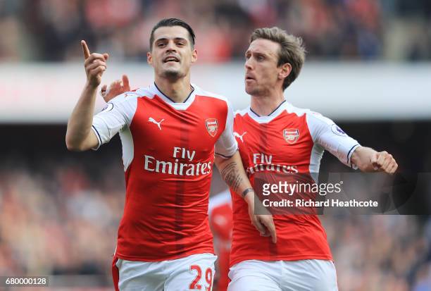Granit Xhaka of Arsenal celebrates scoring his sides first goal with Nacho Monreal of Arsenal during the Premier League match between Arsenal and...