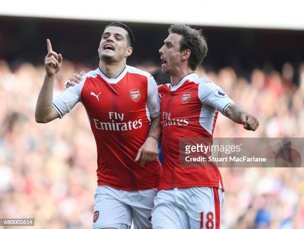 Granit Xhaka celebrates scoring the 1st Arsenal goal with Nacho Monreal during the Premier League match between Arsenal and Manchester United at...