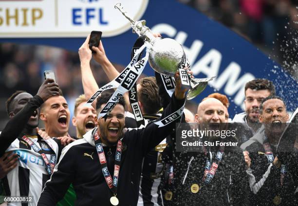 Newcastle United players Jamaal Lascelles and Jonjo Shelvey lift the trophy after winning the Sky Bet Championship title after the match between...