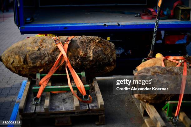 Officers of the Explosive Ordnance Disposal Division showcase two five centner and one ten centner bomb on to a truck after dismantling the bombs on...