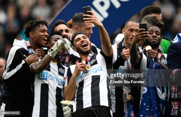 Newcastle United players Vurnon Anita and Achraf Lazaar celebrate by taking selfie photographs after winning the Sky Bet Championship match between...