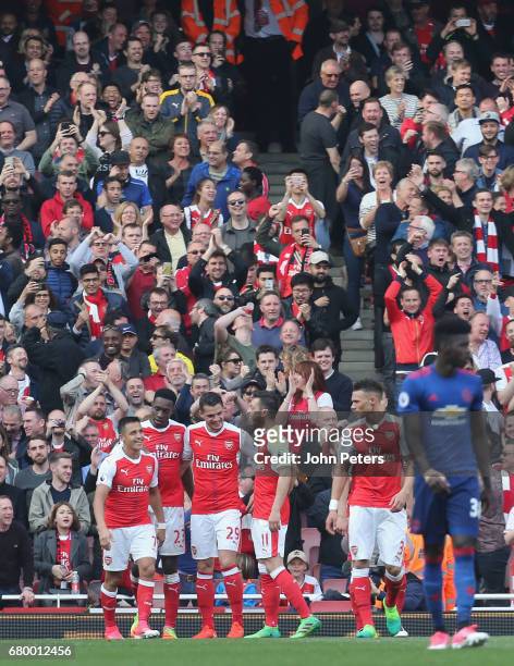 Danny Welbeck of Arsenal celebrates scoring their second goal during the Premier League match between Manchester United and Arsenal at Emirates...
