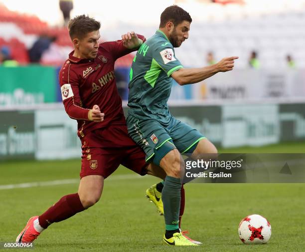 Rifat Zhemaletdinov of FC Rubin Kazan vies for the ball with Bojan Jokich FC Ufa during the Russian Premier League match between FC Rubin Kazan and...