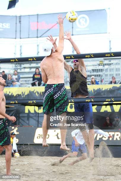 John Hyden jumps to spike the ball over Jake Gibb during the semi final match against at AVP Huntington Beach Open at the Huntington Beach Pier on...