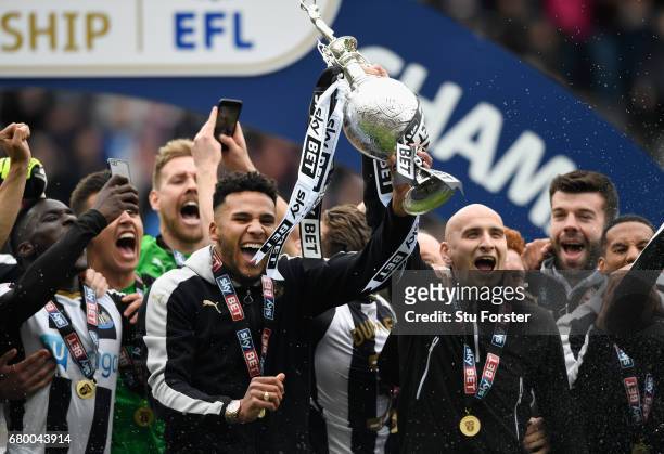 Newcastle United players Jamaal Lascelles and Jonjo Shelvey lift the trophy after winning the Sky Bet Championship title after the match between...