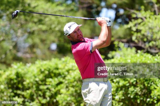 Graeme McDowell of Northern Ireland plays his shot from the fourth tee during the final round of the Wells Fargo Championship at Eagle Point Golf...