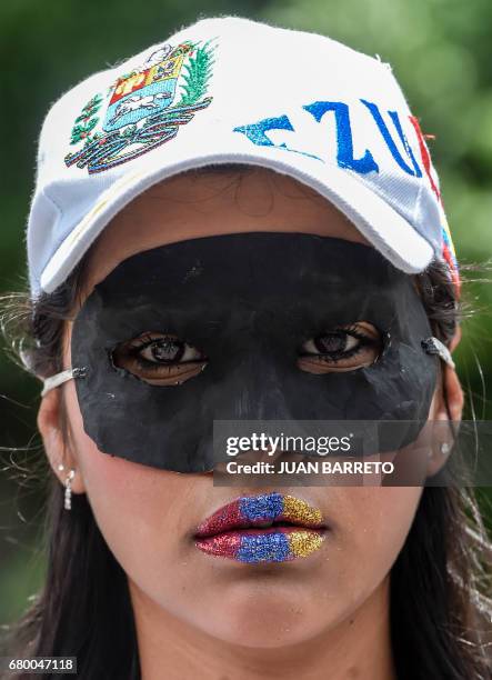 An activist takes part in a demonstration in rejection of the recent deaths of young people by security forces -within opposition protests- in...