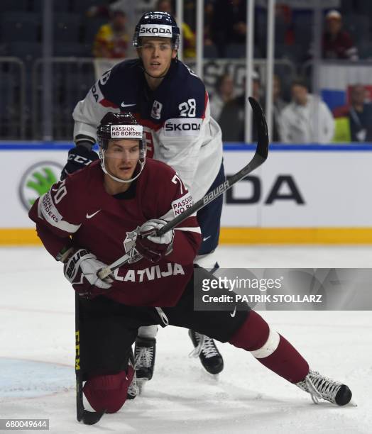 Latvia´s Miks Indarsis and Slovakia´s Martin Gernat vie for the puck during IIHF Icehockey world championship first round match between Latvia and...