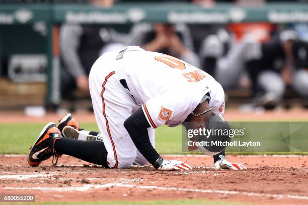 Adam Jones of the Baltimore Orioles reacts after taking a foul tip off his foot in second inning during a baseball game against the Chicago White Sox...