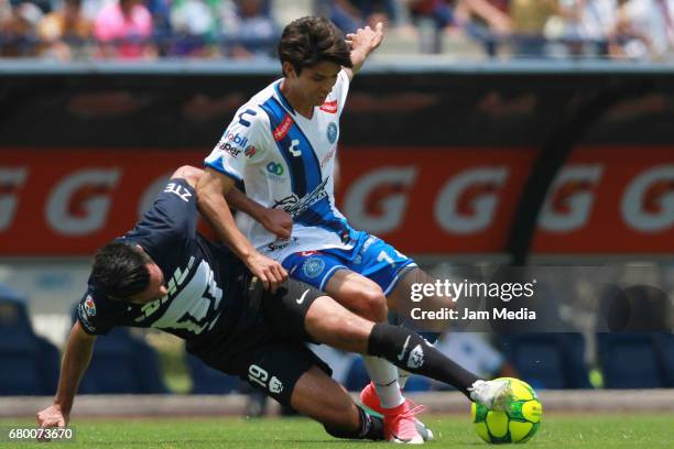 Luis Quintana of Pumas fights for the ball with Carlos Orrantia of Puebla during the 17th round match between Pumas UNAM and Puebla as part of the...