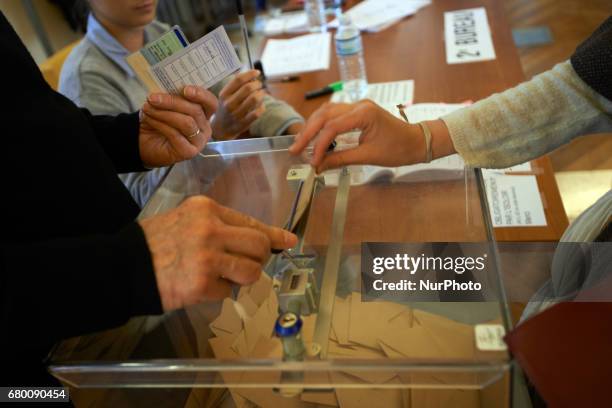Voter oputs his ballot in the urn. Counting of the ballots on the 2nd round of the French presidential election. Emmanuel Macron is elected President...