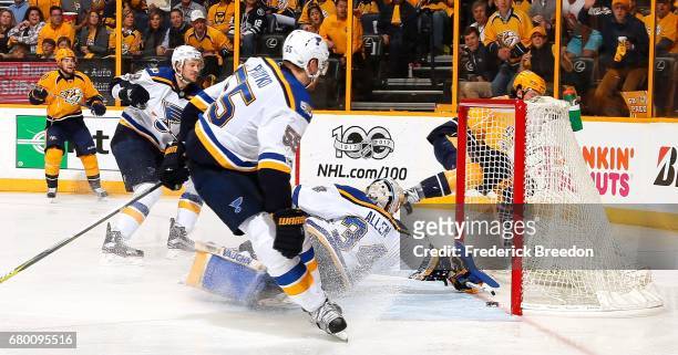 Jay Bouwmeester and Colton Parayko of the St. Louis Blues and Viktor Arvidsson of the Nashville Predators watch as Ryan Johansen scores the eventual...